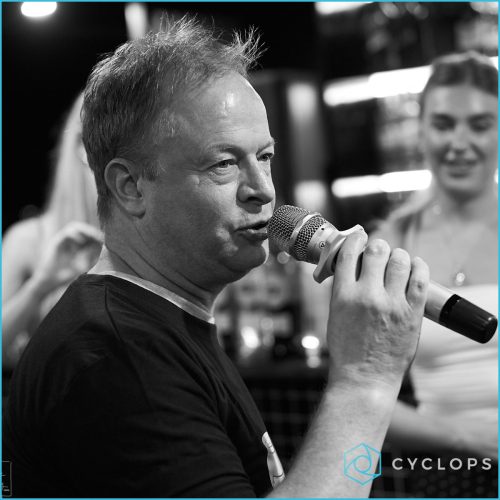 Denis Lacroix holding a microphone